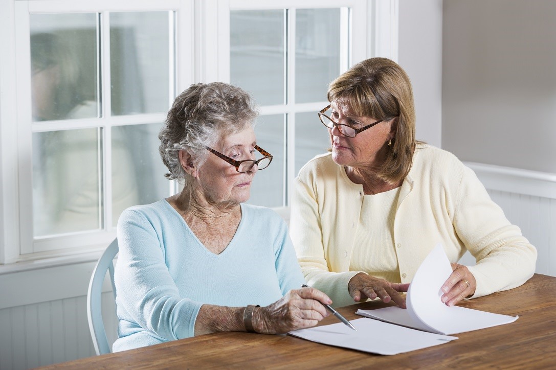 women helping mother with paperwork